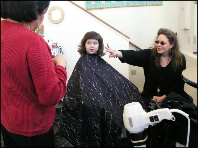 Mommy makes sure the haircut is just right!