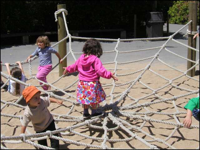 Climbing in the spider web at the zoo
