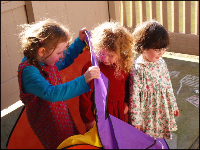 Isabel, Ava, and Hanna playing with the tent