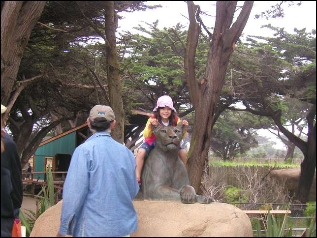 Sydney can climb on a statue of a lion