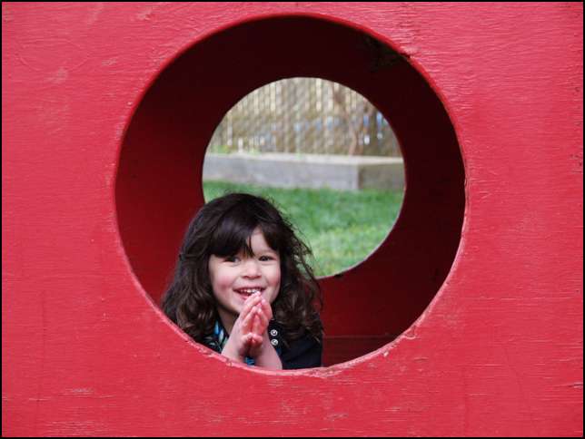 Sydney in the wooden boat in the West AM play yard.