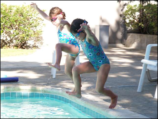 Butch Cassidy & the Sundance Kid!  Ava and Sydney swimming in the courtyard pool.