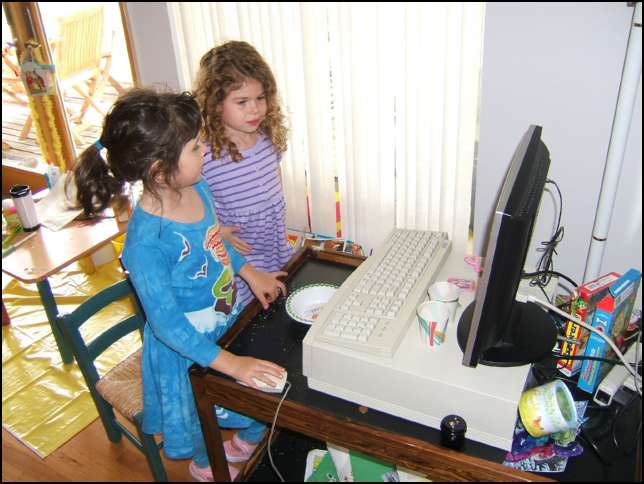 Sydney and Ava play some computer games before baking the cupcakes